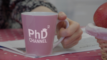 Personne tenant une tasse avec la mention PhD Channel