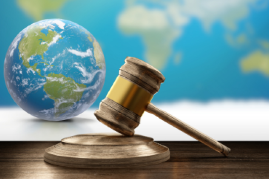 World map, earth globe and wooden judge gavel